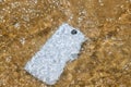 Damage and wet smart phone dropped on flooding with water Royalty Free Stock Photo