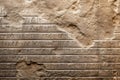 Damaged ancient cuneiform carved on stone wall or rock, fiction view Royalty Free Stock Photo