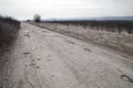 Damaged asphalt pavement road with potholes caused by freeze and thaw cycle during winter Royalty Free Stock Photo