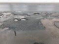 Damaged asphalt road with potholes Royalty Free Stock Photo