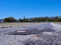 Damaged asphalt road under blue sky Royalty Free Stock Photo