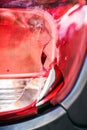 Damaged automotive vehicle taillight, broken car headlight after minor collision