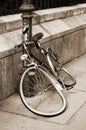 Damaged bicycle locked to an iron pillar Royalty Free Stock Photo