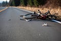 a damaged bicycle lying on a lonely road Royalty Free Stock Photo