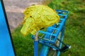 Damaged bicycle seat taped with green and yellow electrical duct tape