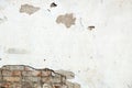 Damaged brick wall, cracked plaster. Textured background Royalty Free Stock Photo