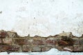 Damaged brick wall, cracked plaster. Textured background Royalty Free Stock Photo