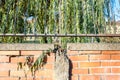 Damaged and broken red brick wall with grunge rusty iron fence close up Royalty Free Stock Photo