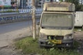 A damaged broken useless car standing road side as a scrap