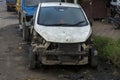A damaged broken useless car standing road side as a scrap