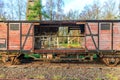 Damaged and broken wooden freight car on disused train tracks at old station Royalty Free Stock Photo