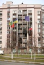 Damaged building facade of multistory house in Bucha after heavy artillery shooting and shelling Royalty Free Stock Photo