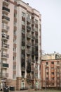 Damaged building facade of multistory house in Bucha after heavy artillery shooting and shelling Royalty Free Stock Photo