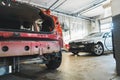 Damaged car with dents and scratches in a car body repair shop ready for repairs