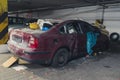 damaged car full of dust, filthy with broken screens and flat tire used as a dump Royalty Free Stock Photo