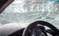 Damaged car window after an accident. Broken windshield as a result of an accident, inside view. Cabin interior details, view from Royalty Free Stock Photo