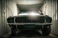 Damaged Classic American Muscle Car Inside a Shipping Cargo Container Royalty Free Stock Photo