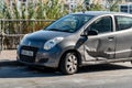 The damaged door of a small Japanese Suzuki Alto hatchback after a car accident because of typical careless driving in Southern