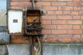 Damaged electrical box with broken wires on the wall Royalty Free Stock Photo