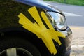 Damaged front fender of the black car in close view. Royalty Free Stock Photo