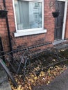A Damaged Front Yard Black Iron Fence at a Terrace House Broken After Being Hit by A Car