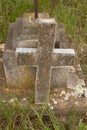 Damaged grave headstone with cross