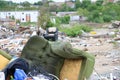 Damaged green armchair on debrise