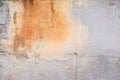 Damaged grey wall with orange paint splash texture background. Creative backdrop. Old building interior fragment