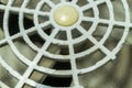 Damaged grille of an old fan in the cooling system of a household distiller. Selective focus