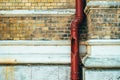 Damaged gutter downspout against brick wall Royalty Free Stock Photo