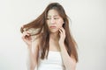 Damaged Hair, frustrated asian young woman, girl hand in holding splitting ends, messy unbrushed dry hair with face shock, long Royalty Free Stock Photo