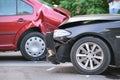 Damaged in heavy car accident vehicles after collision on city street crash site. Road safety and insurance concept Royalty Free Stock Photo