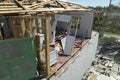 Damaged house roof and walls after hurricane Ian in Florida. Consequences of natural disaster