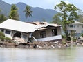 damaged house sinking in to the water in mangrove forest, collapsed old house in the water