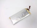 A damaged lithium polymer (LiPo) battery is shown on a white surface Royalty Free Stock Photo