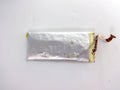 A damaged lithium polymer (LiPo) battery is shown on a white surface Royalty Free Stock Photo