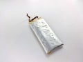 A damaged lithium polymer (LiPo) battery is shown on a white surface Royalty Free Stock Photo