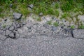 Damaged local asphalt road. A hole on the way leading to the city in Central Europe Royalty Free Stock Photo