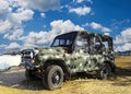 A damaged military armored vehicle, a passenger car , a jeep and equipment on the battlefield. military technics.