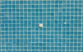 Damaged mosaic tiles falling into empty swimming pool Royalty Free Stock Photo