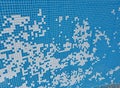 Damaged mosaic tiles falling into empty swimming pool Royalty Free Stock Photo