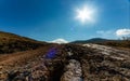 Damaged mountain road and blue sun sky Royalty Free Stock Photo
