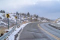 Damaged mountain road with directional road signs Royalty Free Stock Photo