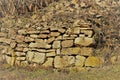 Damaged old vineyard wall made of natural stone blocks