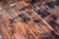 Damaged outdoor wood plate arrange and transform to the floor with the shadow of tree Royalty Free Stock Photo