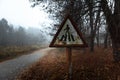 Damaged pedestrian sign at forestal road Royalty Free Stock Photo