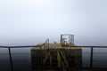 Damaged pier in the mist at morning