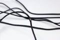 Damaged by rats black electric cord on white background. Dangerous broken power electrical cable Royalty Free Stock Photo