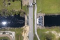 Damaged road bridge destroyed by river after flood water washed away asphalt. Rebuilding of ruined transportation Royalty Free Stock Photo