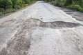 Damaged road in the countryside Royalty Free Stock Photo